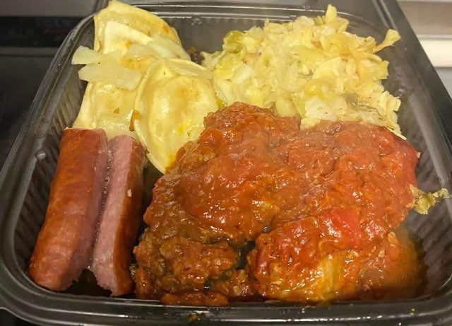A platter with sliced hot dogs, flatbread and cabbage